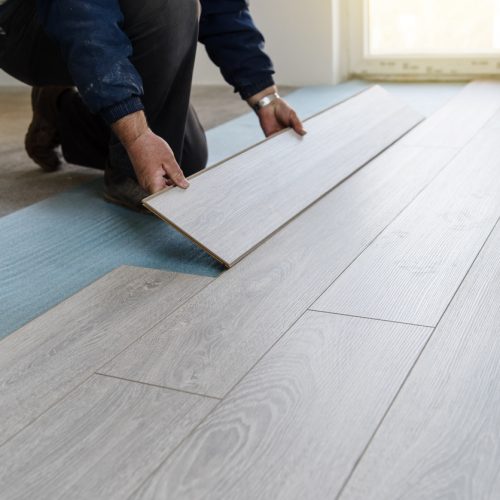 Worker carpenter doing laminate floor work